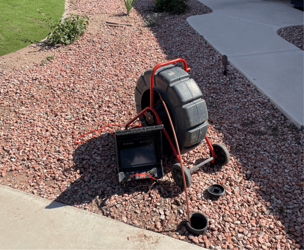 a tire machine outside on some mulch and rocks