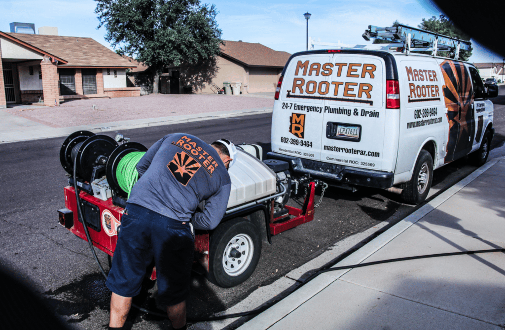 the master rooter van with someone working on it