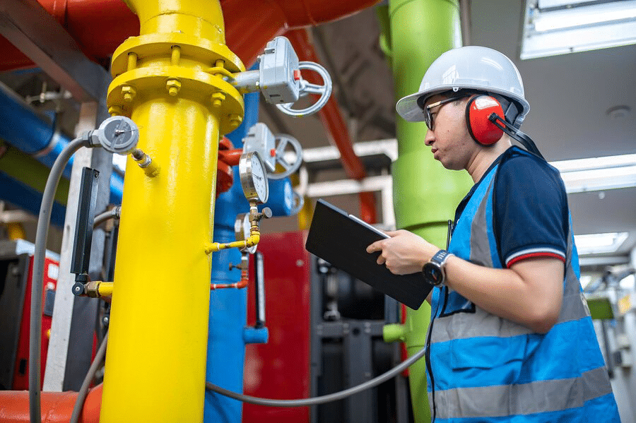 maintenance-technician-heating-plantpetrochemical-workers-supervise-operation-gas-oil-pipelines-factoryengineers-put-hearing-protector-room-with-many-pipes_44277-24173