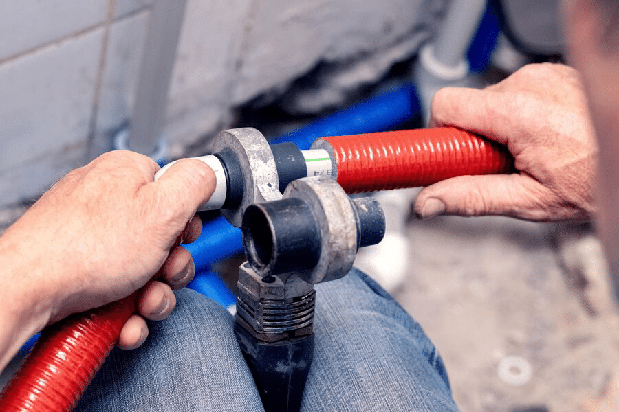 work-installation-heating-plumbing-master-connects-plastic-pipes-with-soldering-iron_199743-13331
