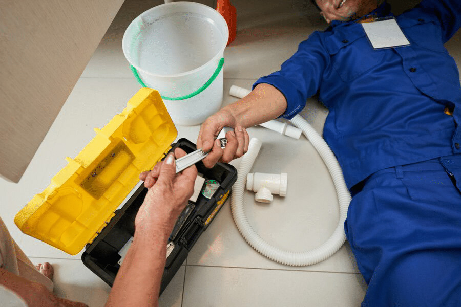 top-view-plumber-checking-kitchen-fixtures_1098-17864